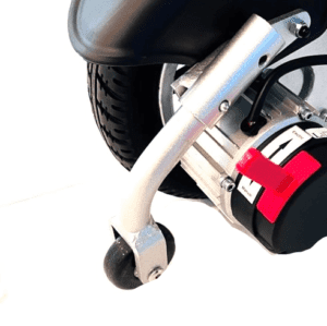 A close up of the motor and tire on a scooter.